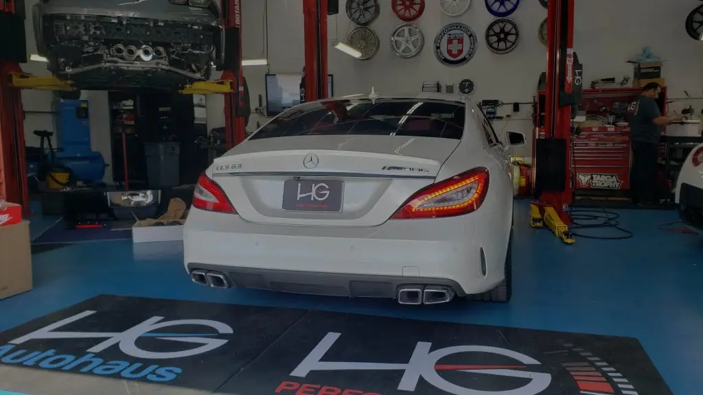 White Mercedes-Benz CLS in the HG Performance service bay in San Marcos