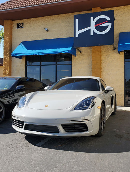 White Porsche parked at HG