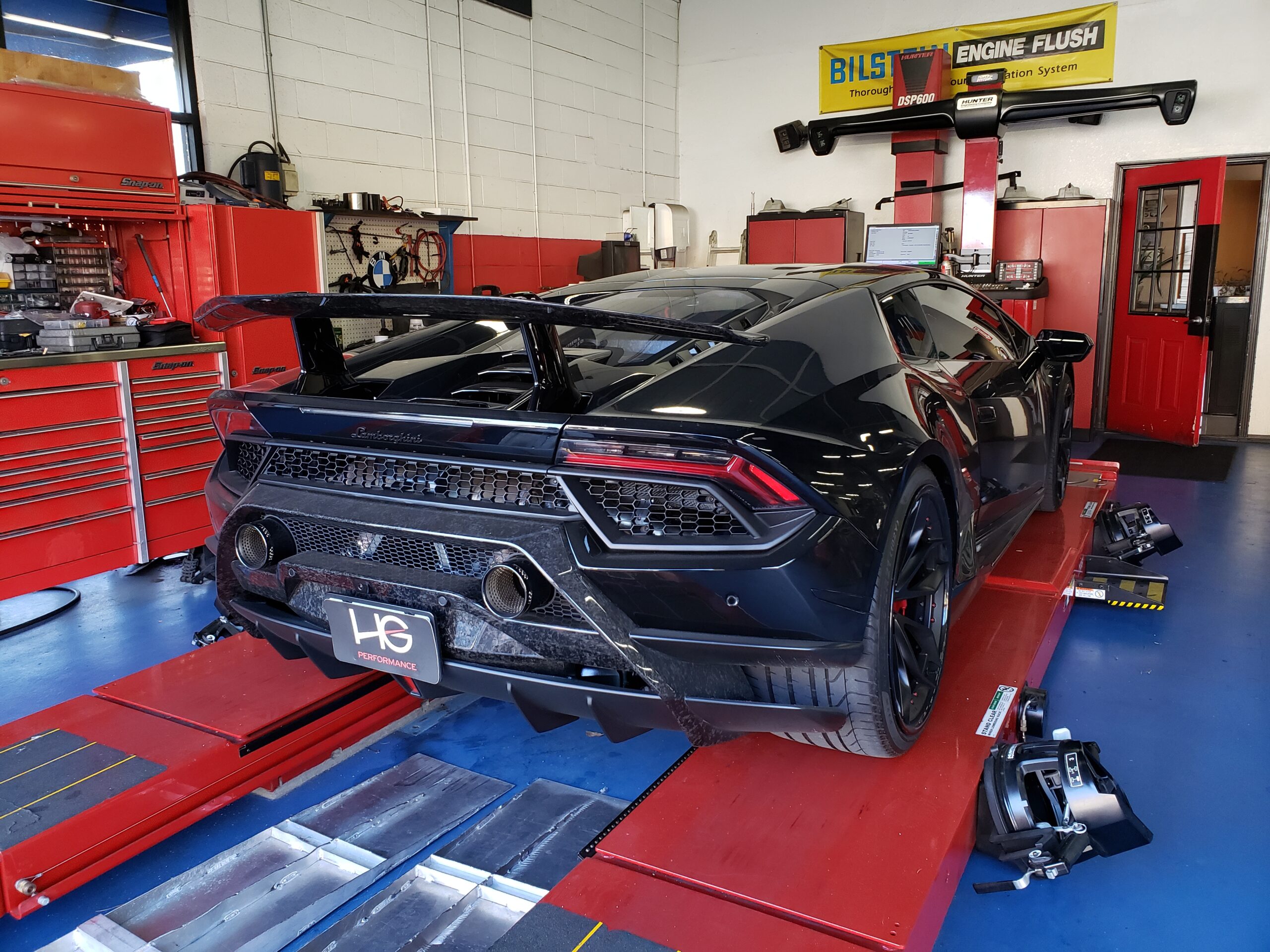 Hunter HawkEye laser alignment machine in use on exotic car