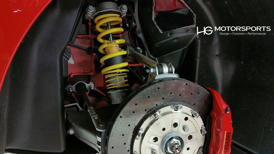 Modified Ferrari 458 Spider showcasing lowered suspension and custom wheels