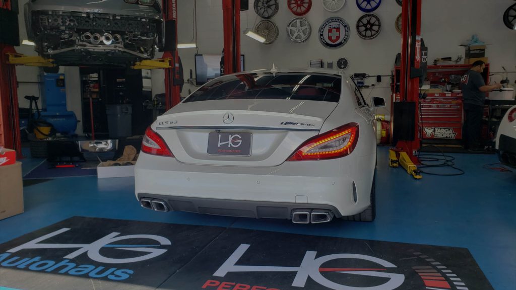 White Mercedes-Benz CLS in the HG Performance service bay in San Marcos
